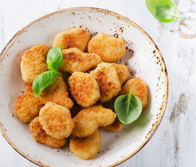 Crispy chicken nuggets on plate.