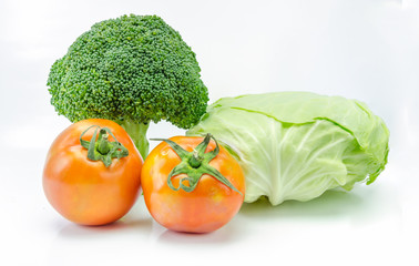 Broccoli and tomato on white background.