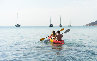 Couple on kayak on the beautiful bay . Back view