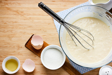 Ingredients for making pancakes and raw dough