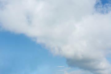fluffy cloud above blue sky background