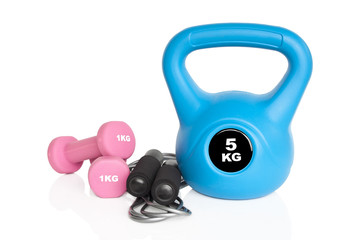 Fitness equipment. Dumbbells, kettlebell and skipping rope isolated on white background. Weights for a fitness training.