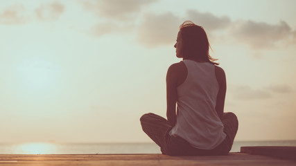 Young woman is doing yoga