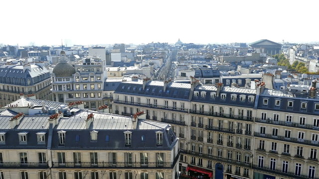 PARIS, FRANCE - OCTOBER 11, 2015: Aerial view from the terrace of store Printemps, with roofs and Madelaine church.