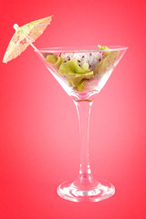 cocktail sushi with mini umbrella and salad on pink background 