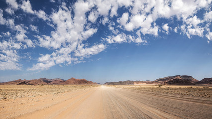 Fototapeta na wymiar Namibian typical street with beautiful clouds 