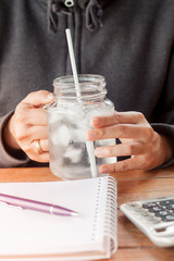 Woman's hand holding a cold glass of water