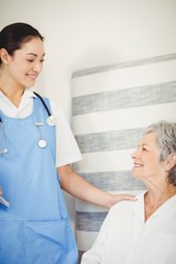 Fototapeta premium Nurse taking care of sick senior woman