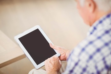 Senior man using digital tablet