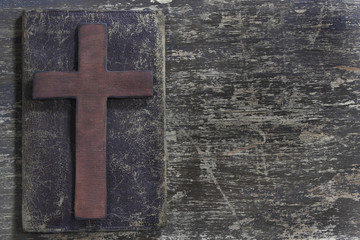 Cross and old leather  on old wooden board