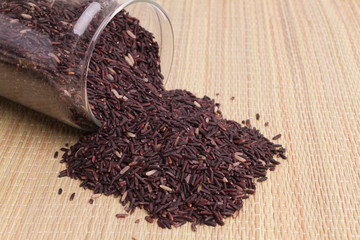 raw purple rice berry on mat