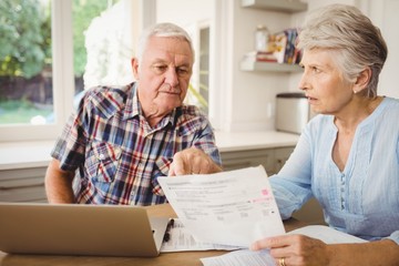 Worried senior couple discussing their bills