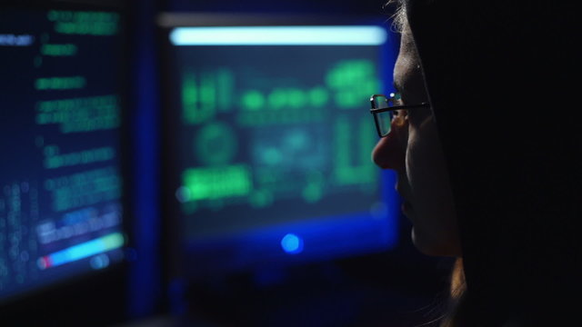 female hacker works at the computer