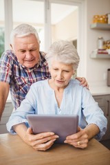 Senior couple looking at a digital tablet