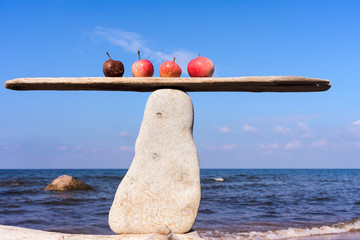 Four apples on stone