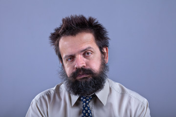 Exhausted man with bushy hair and beard