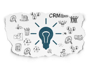 Finance concept: Light Bulb on Torn Paper background