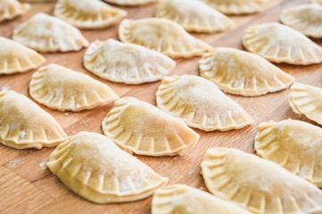 Fototapeta na wymiar Making of homemade dumplings pastry tortellini or ravioli