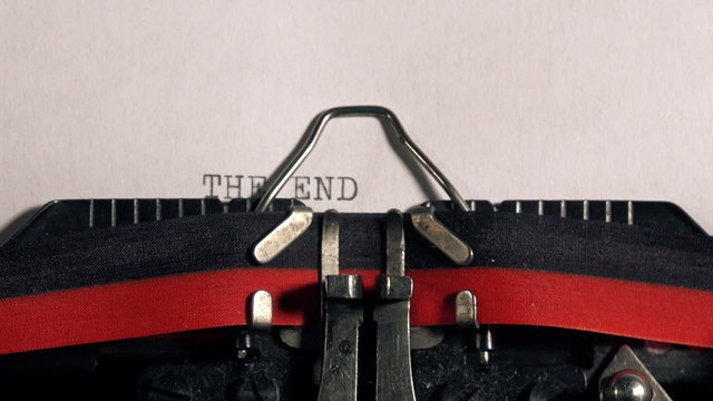 The End on old typewriter, typing text on vintage machine.