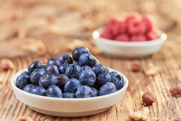 Super food breakfast with bilberries, nuts and rapsberries