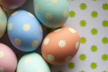 Colored Easter eggs on patterned background