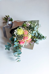Bouquet of spring flowers with pink roses on white desk. Selective focus.