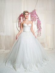 Fototapeta premium portrait of blonde bride in interior