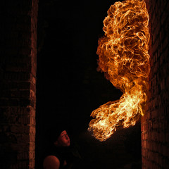 Fire artist performing fire breathing