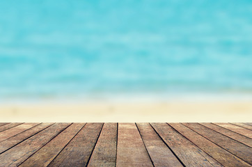 Wood table on blur sea water and summer background
