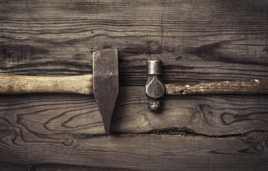 Old retro hammers on wooden workbench