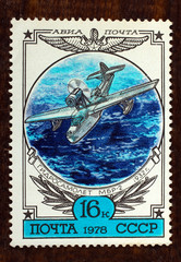 The history of aviation, Russian hydroplane "MBR-2" (1932), postage stamp, USSR, 1978 on wooden brown background