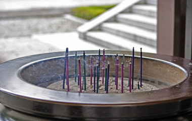 Fototapeta na wymiar Burning incense sticks in Buddhist temple.