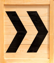 Fototapeta premium Black arrow on wood wall.