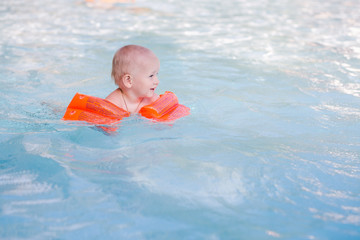 Cute little baby in swimming pool