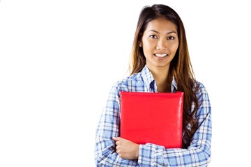 Obraz premium Smiling asian woman holding red book