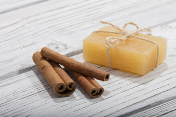 handmade soap with cinnamon on wooden background