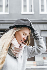 Girl holding her hat for wind blow