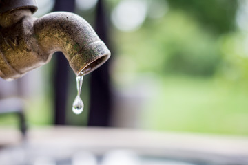 old rusty tap leaking water