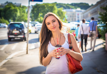 Young happy caucasian woman enjoy coffee in morning city park outdoor. Relax lifestyle summer concept