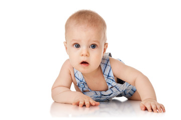 Baby is lying on floor, isolated on white