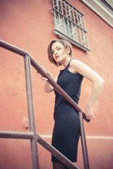 Fototapeta na wymiar Vogue model in the black dress outdoor portrait