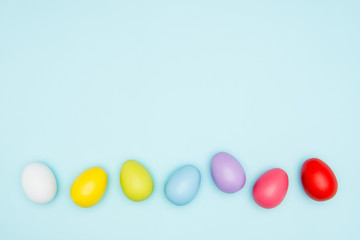 Colorful easter eggs on pastel background