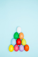 Colorful easter eggs on pastel background, Triangle Shape