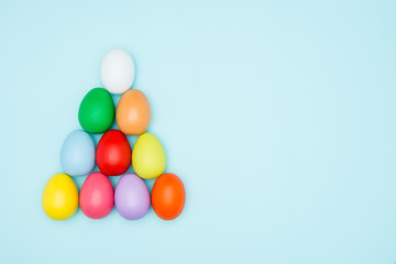 Colorful easter eggs on pastel background