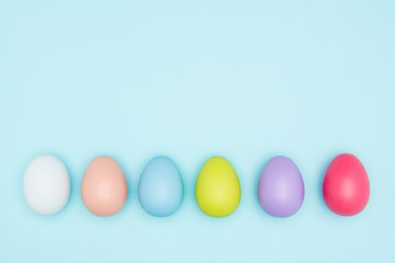 Colorful easter eggs on pastel background