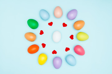 Colorful easter eggs on pastel background