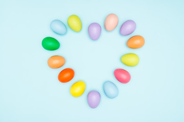 Colorful easter eggs on pastel background