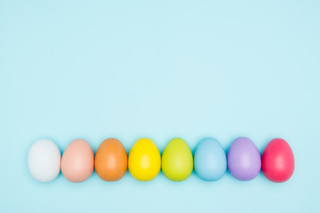 Colorful easter eggs on pastel background