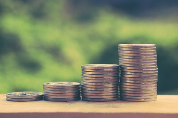 Money coin stack growing graph with filter effect retro vintage styleMoney coin stack growing graph with filter effect retro vintage style