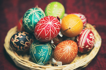 Vintage style photo from decorated Easter eggs in a basket with traditional hungarian patterns